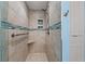 Tiled walk-in shower featuring stylish fixtures, a built-in seat, and convenient storage niches at 5806 Gulf Dr # 201, Holmes Beach, FL 34217