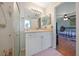 Bathroom features a shower, a vanity with mirror and a view of the bedroom at 590 Ridgewood Nw St, Port Charlotte, FL 33952