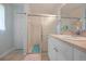 Bathroom features a shower with sliding glass doors, a vanity with mirror, sink, and a linen closet at 590 Ridgewood Nw St, Port Charlotte, FL 33952