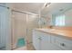 Bathroom features a shower with sliding glass doors, a vanity with mirror and sink at 590 Ridgewood Nw St, Port Charlotte, FL 33952