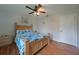Cozy bedroom featuring wood-look flooring and a ceiling fan with light fixture at 590 Ridgewood Nw St, Port Charlotte, FL 33952