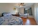 Bright bedroom with two beds, wood-look flooring, and a window at 590 Ridgewood Nw St, Port Charlotte, FL 33952