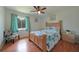 Comfortable bedroom with wood floors, a queen-size bed, and a view of the backyard at 590 Ridgewood Nw St, Port Charlotte, FL 33952