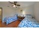 Bright bedroom with two beds and a ceiling fan with light fixture at 590 Ridgewood Nw St, Port Charlotte, FL 33952