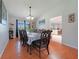 Elegant dining room with wood floors, traditional furnishings, and a view to the kitchen at 590 Ridgewood Nw St, Port Charlotte, FL 33952