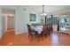 Formal dining room with wood floors, traditional furnishings, and a view to the kitchen at 590 Ridgewood Nw St, Port Charlotte, FL 33952
