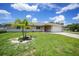 Beautiful home with well-manicured lawn, landscaped garden, and a two-car garage at 590 Ridgewood Nw St, Port Charlotte, FL 33952