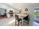 Bright kitchen boasts white cabinetry, stainless steel appliances, and a breakfast bar with seating at 590 Ridgewood Nw St, Port Charlotte, FL 33952