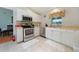 Bright kitchen with stainless steel appliances, tiled floors, and ample counter space at 590 Ridgewood Nw St, Port Charlotte, FL 33952