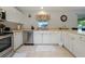 Clean and functional kitchen with stainless steel appliances and ample cabinet space at 590 Ridgewood Nw St, Port Charlotte, FL 33952