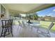 Enclosed lanai with tile floors, dining table, and ceiling fan at 590 Ridgewood Nw St, Port Charlotte, FL 33952
