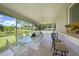 Enclosed lanai featuring tile flooring, dining table, and ceiling fan at 590 Ridgewood Nw St, Port Charlotte, FL 33952