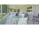 Enclosed lanai with tile flooring, dining table, and ceiling fan at 590 Ridgewood Nw St, Port Charlotte, FL 33952