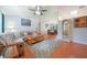 Bright living room featuring wood floors, vaulted ceiling, and comfortable seating at 590 Ridgewood Nw St, Port Charlotte, FL 33952