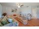 Spacious living room with wood floors, ceiling fan, and a view of the lanai at 590 Ridgewood Nw St, Port Charlotte, FL 33952