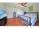 Relaxing main bedroom featuring wood floors, ceiling fan, and a queen-size bed at 590 Ridgewood Nw St, Port Charlotte, FL 33952