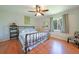 Comfortable bedroom with wood floors, ceiling fan, and a view of the backyard at 590 Ridgewood Nw St, Port Charlotte, FL 33952