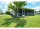 Cozy screened-in porch nestled in the yard with ample space and natural light at 590 Ridgewood Nw St, Port Charlotte, FL 33952