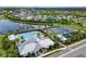 Aerial view of a community pool, tennis courts, a playground, a lake and houses at 5958 164Th E Ave, Parrish, FL 34219