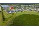 Aerial view of the property showcasing the surrounding community, landscaping, and nearby water features at 5958 164Th E Ave, Parrish, FL 34219