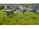 Aerial view showcases the spacious backyard and patio, surrounded by lush greenery and landscaping at 5958 164Th E Ave, Parrish, FL 34219