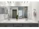 Bright bathroom featuring double sinks, white countertops, and gray cabinetry at 5958 164Th E Ave, Parrish, FL 34219