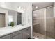 Bright bathroom featuring a glass shower enclosure, white countertop, and gray cabinetry at 5958 164Th E Ave, Parrish, FL 34219