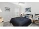 This bedroom showcases a cozy bed with decorative pillows, a nautical painting, and natural light at 5958 164Th E Ave, Parrish, FL 34219