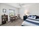 Bright bedroom features a ceiling fan, desk, and comfortable bed with nautical-themed bedding at 5958 164Th E Ave, Parrish, FL 34219