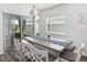 Bright dining area featuring a rustic table, stylish seating, and large windows at 5958 164Th E Ave, Parrish, FL 34219