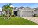 Well-kept single-story home with a two-car garage, featuring a tidy lawn and verdant landscaping, perfect for curb appeal at 5958 164Th E Ave, Parrish, FL 34219