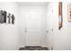 Bright foyer with a white front door, hardwood floors, and stylish wall decor, creating a welcoming entrance at 5958 164Th E Ave, Parrish, FL 34219