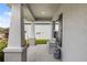 Charming covered front porch featuring a quaint bench and decorative accents, offering a relaxing outdoor seating area at 5958 164Th E Ave, Parrish, FL 34219