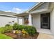 Cozy front porch area with vibrant landscaping, providing a welcoming entrance to the home and enhanced curb appeal at 5958 164Th E Ave, Parrish, FL 34219