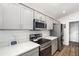 Modern kitchen featuring stainless steel appliances, gray cabinets, and ample countertop space at 5958 164Th E Ave, Parrish, FL 34219