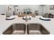 Bright kitchen island featuring sleek countertops and double sink, perfect for entertaining guests at 5958 164Th E Ave, Parrish, FL 34219
