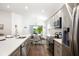 Bright kitchen offers stainless steel appliances, stylish gray cabinetry and an adjacent dining area at 5958 164Th E Ave, Parrish, FL 34219