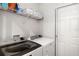 Functional laundry room with modern washer and dryer, storage shelves, and a bright, clean appearance at 5958 164Th E Ave, Parrish, FL 34219