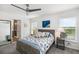 Bright main bedroom featuring large windows, ensuite bathroom, and coastal-themed decor at 5958 164Th E Ave, Parrish, FL 34219