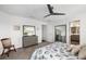 Bright main bedroom featuring gray dresser, coastal themed decor, and ensuite bathroom at 5958 164Th E Ave, Parrish, FL 34219