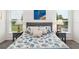 Bright main bedroom with coastal decor featuring bedside lamps and matching side tables at 5958 164Th E Ave, Parrish, FL 34219