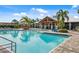 Resort-style pool surrounded by palm trees and lounge chairs, perfect for relaxation at 5958 164Th E Ave, Parrish, FL 34219