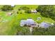 Expansive aerial view of a home with a screened-in pool and vast green land at 5981 Jim Davis Rd, Parrish, FL 34219