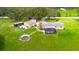 Large lot with a yellow home, detached garage, a screened-in patio, and a round pool for serene countryside living at 5981 Jim Davis Rd, Parrish, FL 34219
