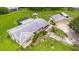 Sprawling aerial shot featuring a home with a pool, outbuildings, and lush greenery at 5981 Jim Davis Rd, Parrish, FL 34219