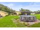 Backyard featuring a above ground pool and a relaxing screened in patio with home and detached garage at 5981 Jim Davis Rd, Parrish, FL 34219