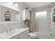 Clean bathroom features a single sink vanity, a tub-shower, and built-in shelving at 5981 Jim Davis Rd, Parrish, FL 34219