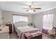 Comfortable bedroom with a ceiling fan, wood-look tile flooring, and natural light from the window at 5981 Jim Davis Rd, Parrish, FL 34219