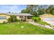 Inviting yellow single-story home with a well-manicured front yard and landscaping at 5981 Jim Davis Rd, Parrish, FL 34219