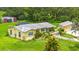 Captivating view of a home, showcasing a lush yard, pool, and outbuildings, exuding charm at 5981 Jim Davis Rd, Parrish, FL 34219